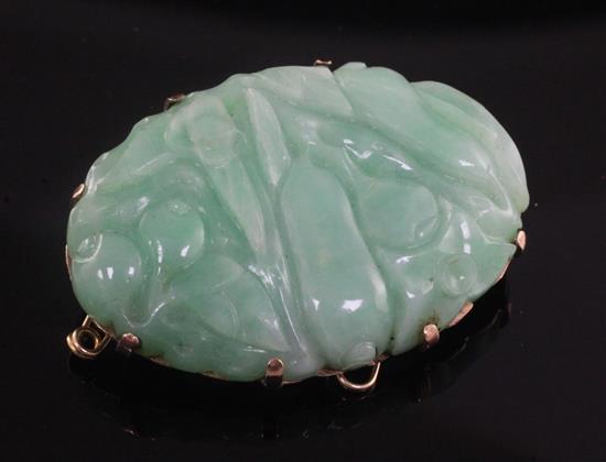 A gold mounted jadeite oval brooch, 41mm.